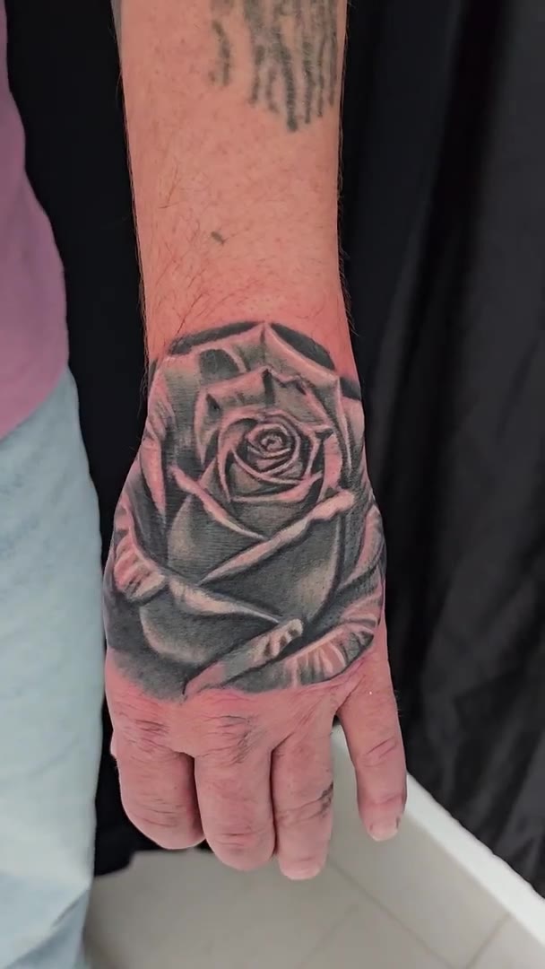 Black-and-grey cover-up tattoo on the hand by Guy Abergel